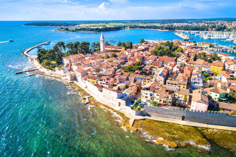 Aerial view of Vrsar’s red-roofed old town beside the Adriatic and its marina.