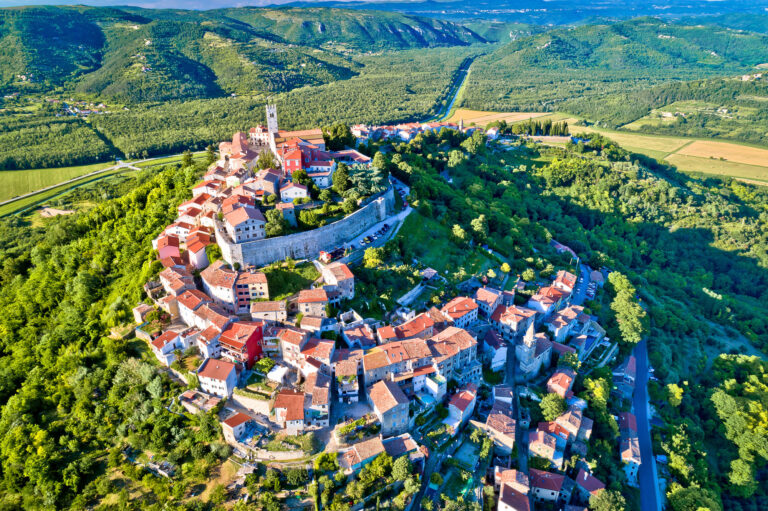 Aerial view of Motovun’s walled hilltop old town amid green Istrian hills