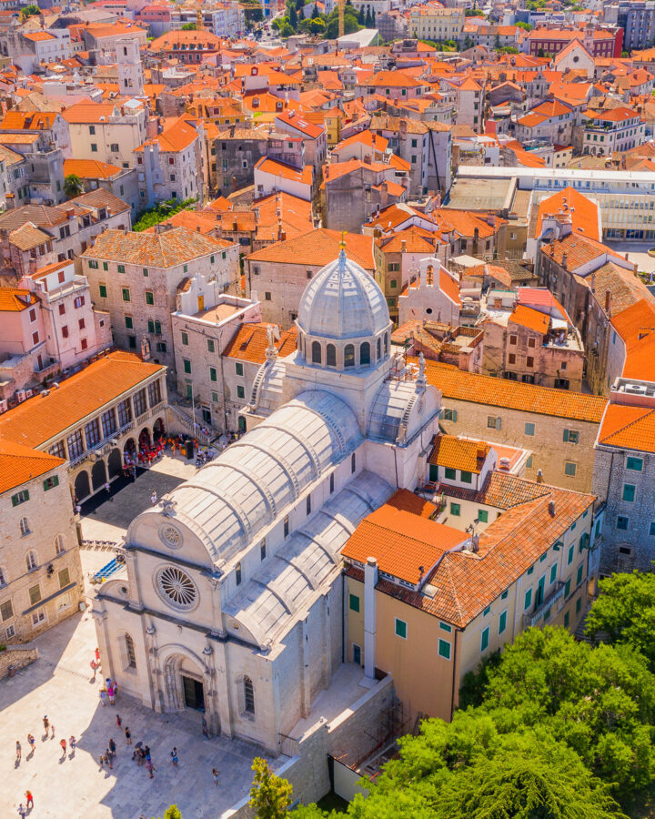 Aerial view of St James Cathedral amid Šibenik’s stone old town and waterfront.