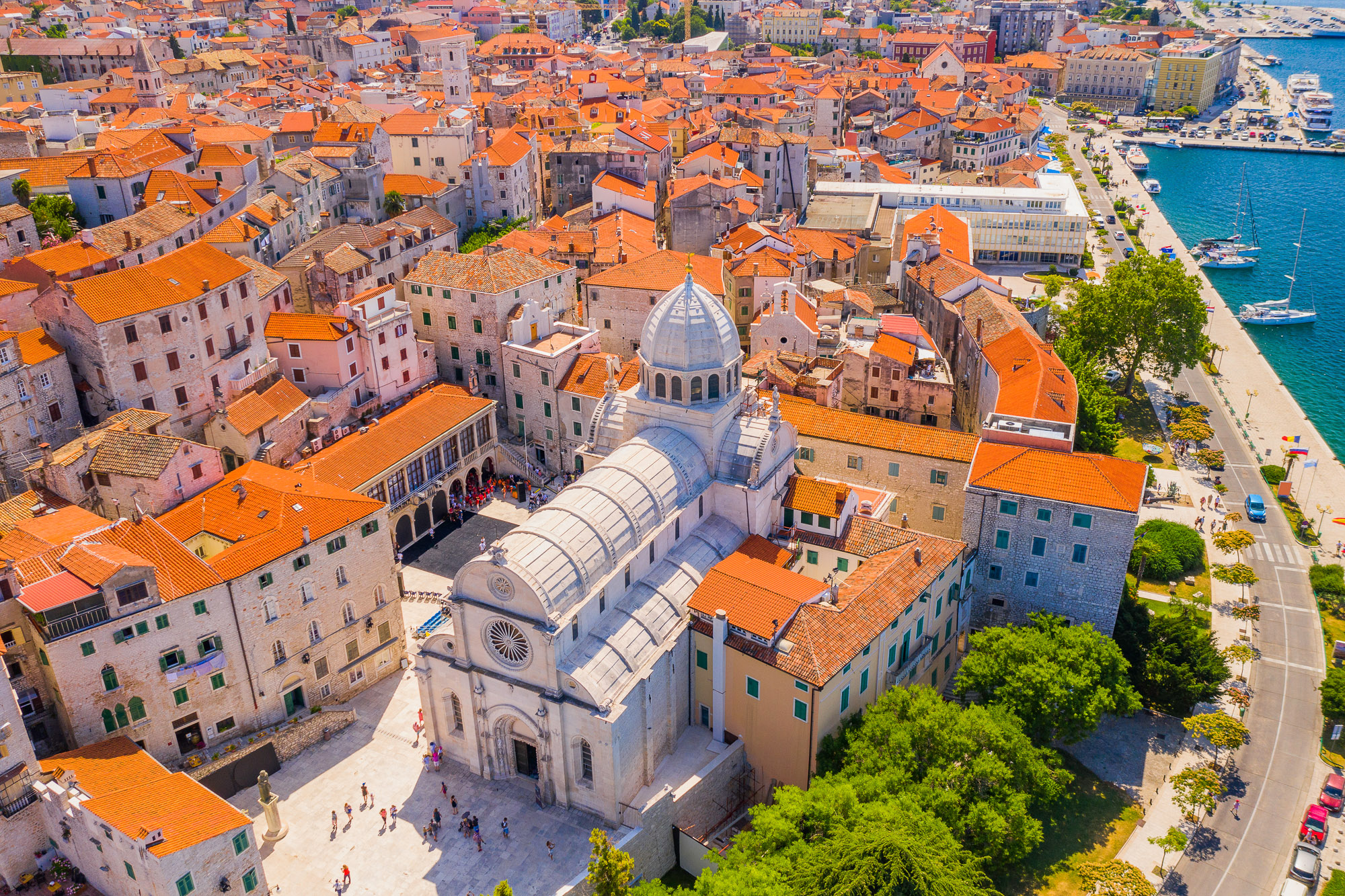 Aerial view of St James Cathedral amid Šibenik’s stone old town and waterfront.