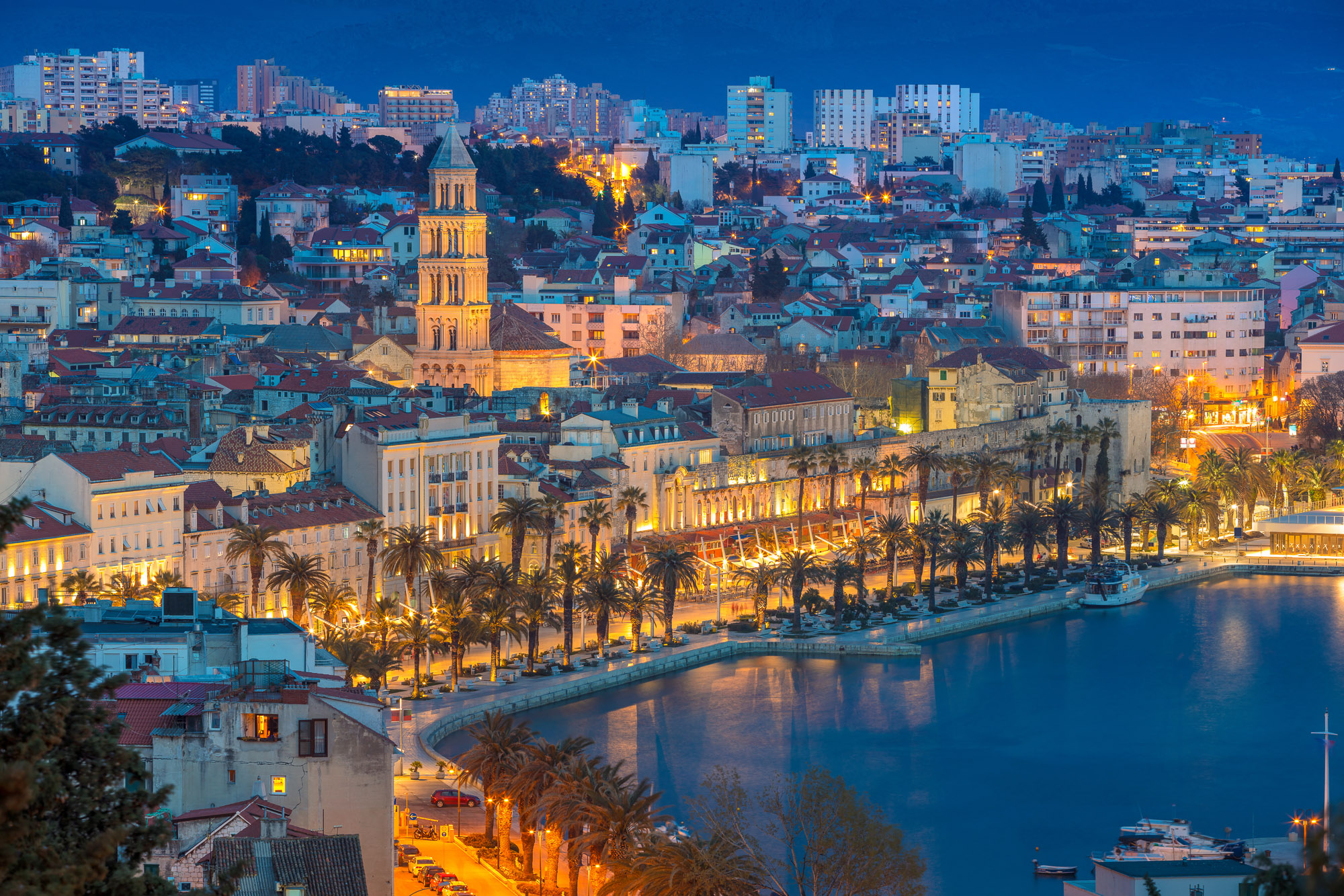 Split Riva waterfront and the cathedral bell tower in Diocletian’s Palace at dusk, Dalmatia, Croatia