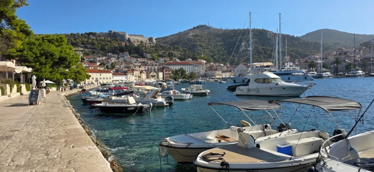 Boats fill Hvar Town harbour beneath the hillside fortress and waterfront buildings.