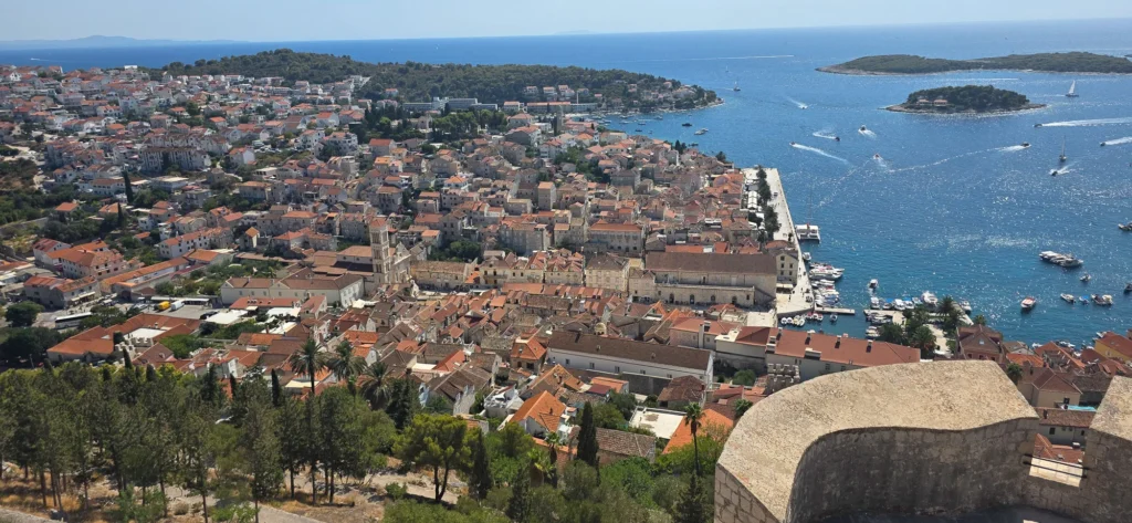 Panoramic view over Hvar Town’s red-roofed old town, harbour and the islands offshore