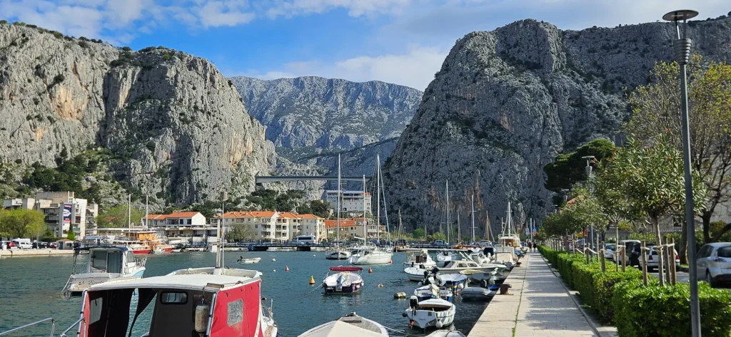 Boats line the Omiš waterfront beneath the steep cliffs of the Cetina canyon.