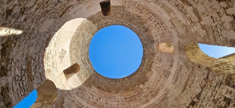 Looking up through the circular oculus in the stone dome of Diocletian’s Palace Vestibule in Split.