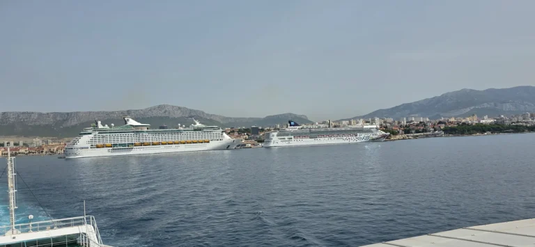 Cruise ships moored in Split harbour, with the city and mountains along the waterfront.